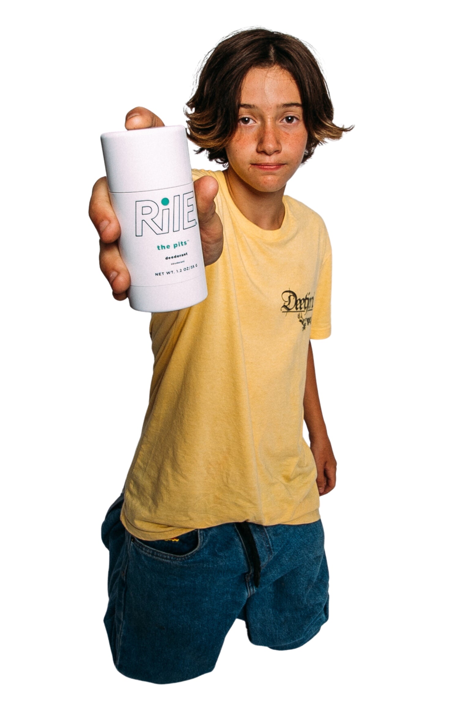 A young teen or tween boy is holding the Rile aluminum free deodorant stick to camera. This kid needs teen hygiene.