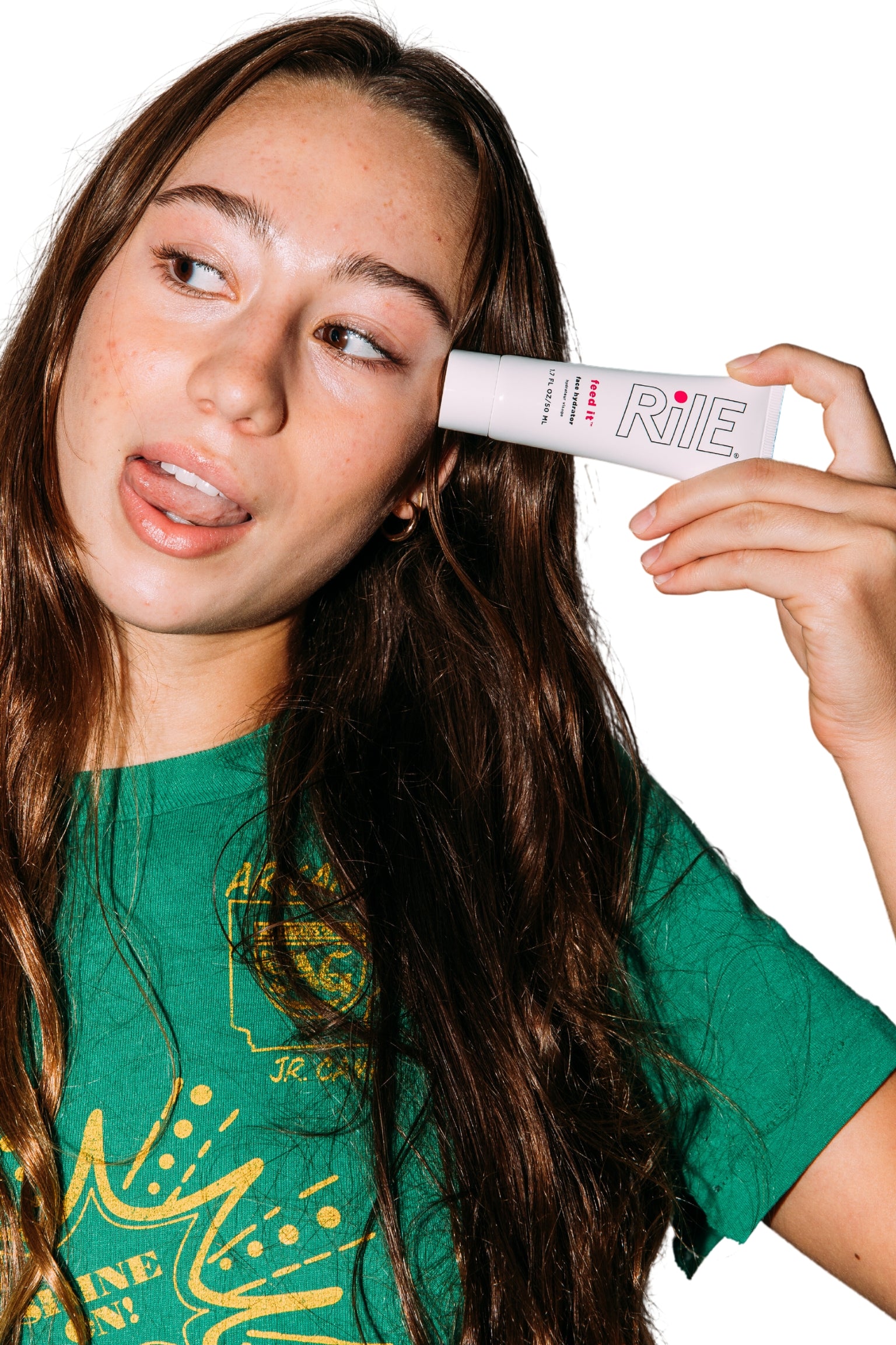 A young teen or tween girl is holding the Rile hydrator moisturizer.